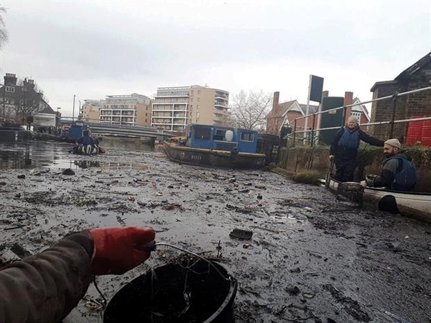 An oil spill in 2018 turned a stretch of the river Lea black, affecting boaters and the environment. Photograph: London Borough of Hackney