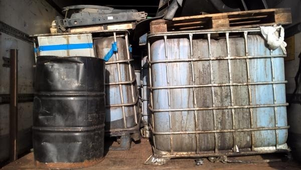 Containers of waste oil dumped in a truck