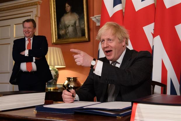 Prime minister Boris Johnson signs the UK-EU Trade and Cooperation Agreement on 30 December. Green groups are worried it does not contain sufficient protections for environmental standards. Photo: Leon Neal / POOL / AFP / Getty Images