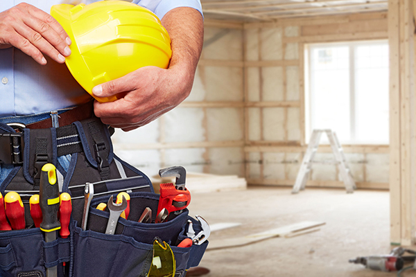 Man holding hard had and tools