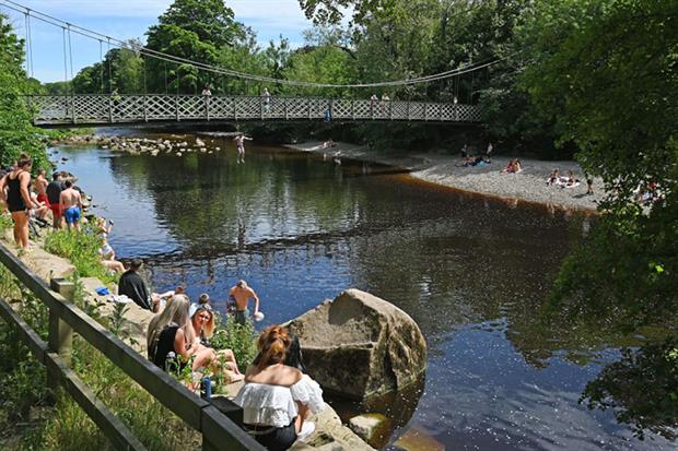 Bathers at the river Wharfe in Ilkley. (Photo by PAUL ELLIS/AFP via Getty Images)