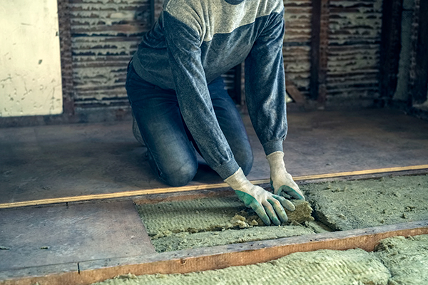 Woman insulating a loft