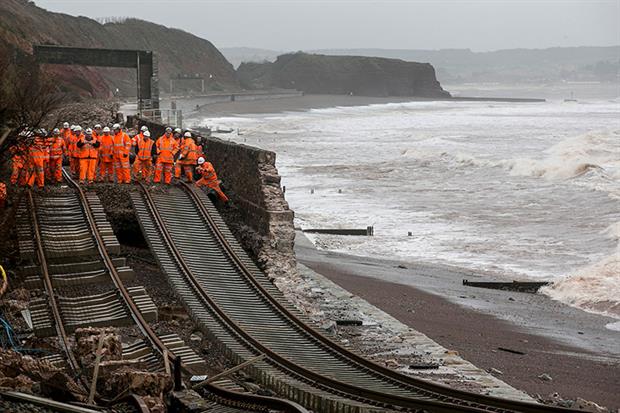 Railway workers inspect the main Exeter to Plymouth railway line that was closed due to parts of it being washed away by the sea at Dawlish on February 5, 2014 in Devon. Photograph: Matt Cardy/Getty Images