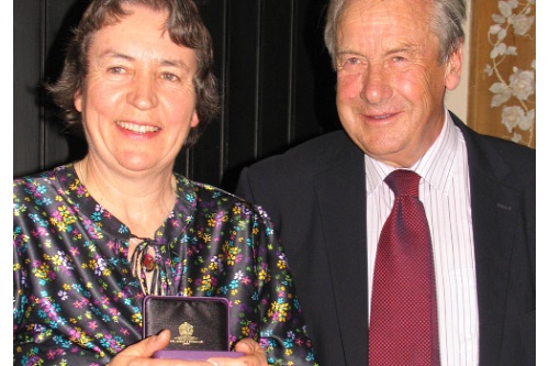 Dr Angela Berrie receives the award from EKFS president Simon Brice - image:EMR