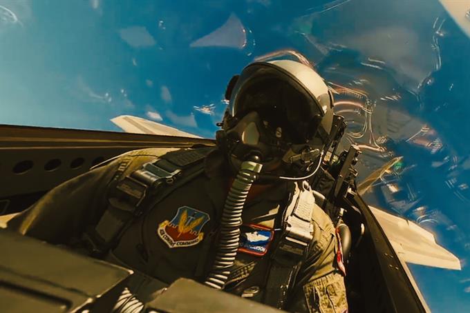Inside view of United States Air Force fighter jet cockpit showing pilot flying upside-down