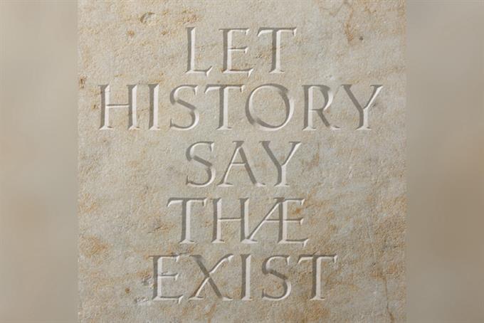 Letters carved into stone reading "Let History Say Thæ Exist"
