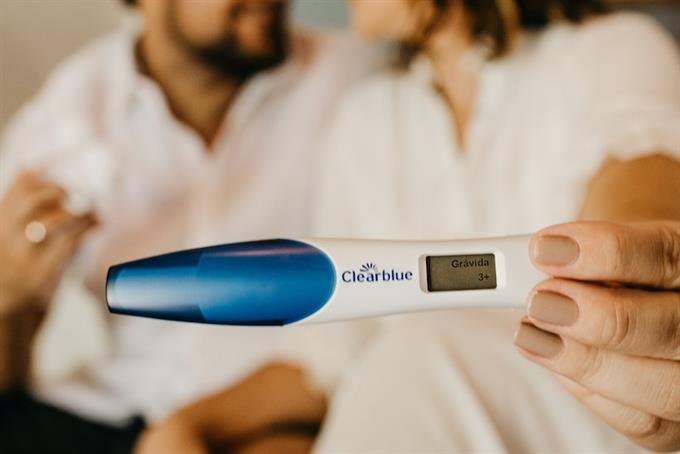 Couple holding up pregnancy test