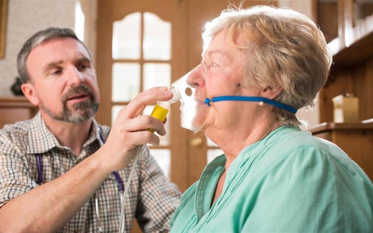 Doctor helping woman with an oxygen mask