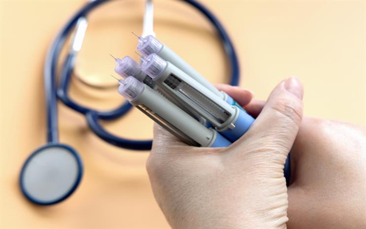 Hand holding weight loss medications