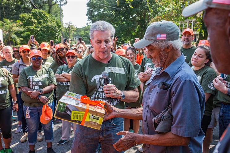 Man gives another man gift from Home Depot