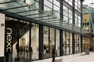 Next sales boosted by warmer weather