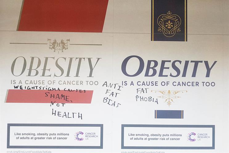 Cancer Research: poster graffitied at Richmond Tube station in London