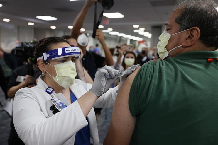 A healthcare worker in Miami gets vaccinated for COVID-19 this week. (Photo credit: Getty Images)