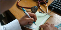 GP writing a prescription (Photograph: J H Lancy/HML)