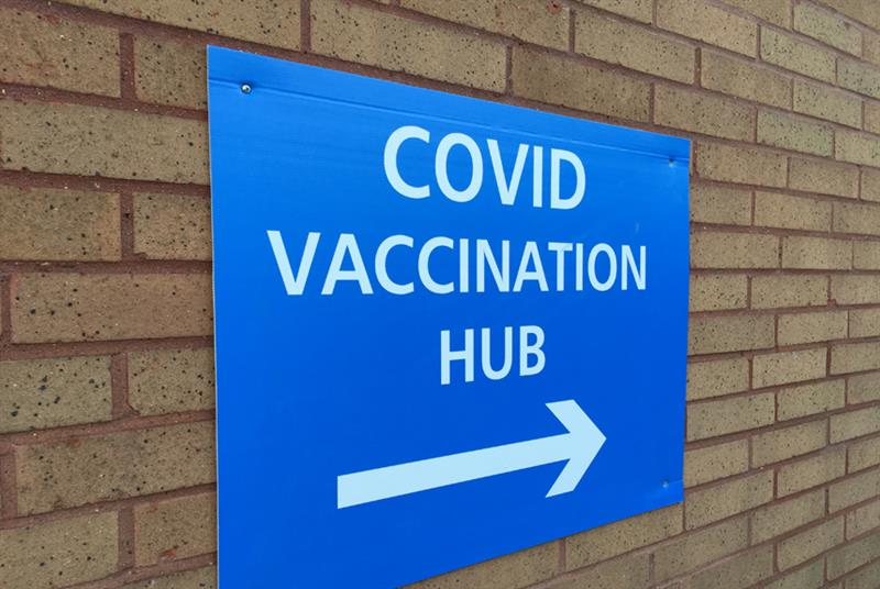 Sign pointing to entrance of COVID-19 vaccination hub