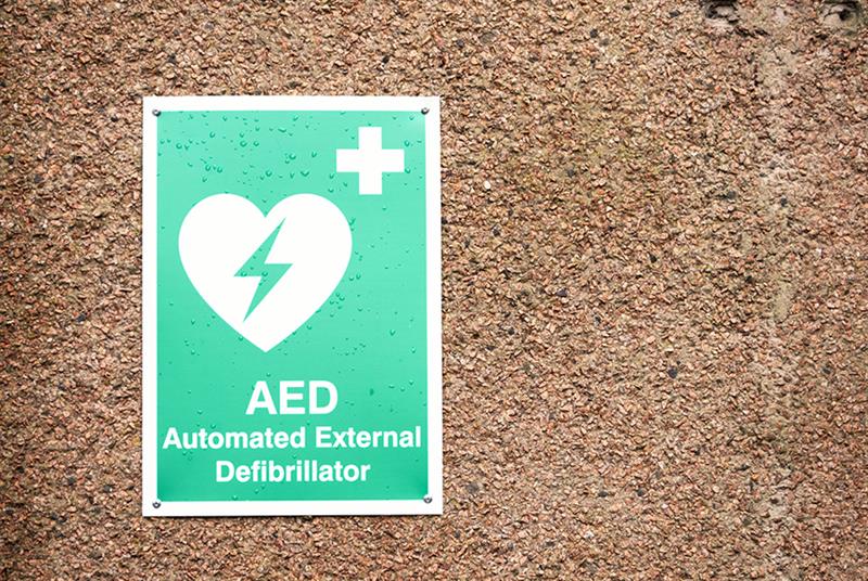 AED (Atomated External Defiibrillator) green and white sign on a wall