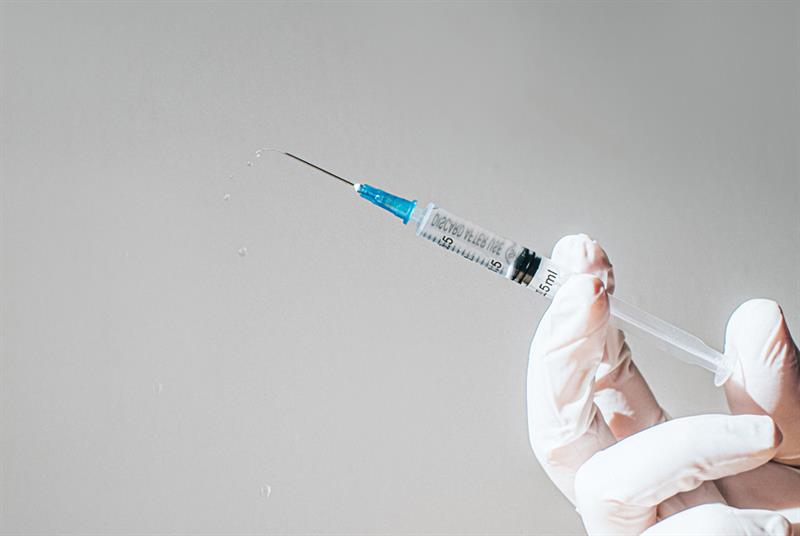 Syringe holding dose of COVID-19 vaccine