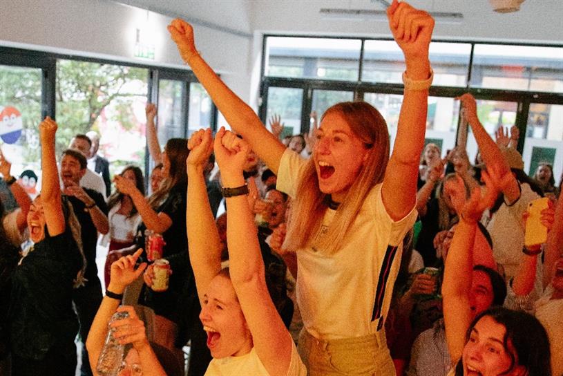 Fans celebrate the Lionesses's success at the Indivisa HQ last night