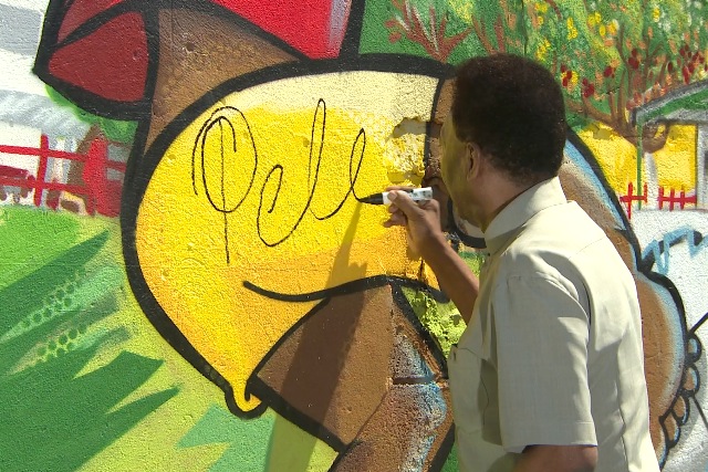 Pele: Brazilian footballing legend signs wall of state-of-the-art pitch in Rio favela