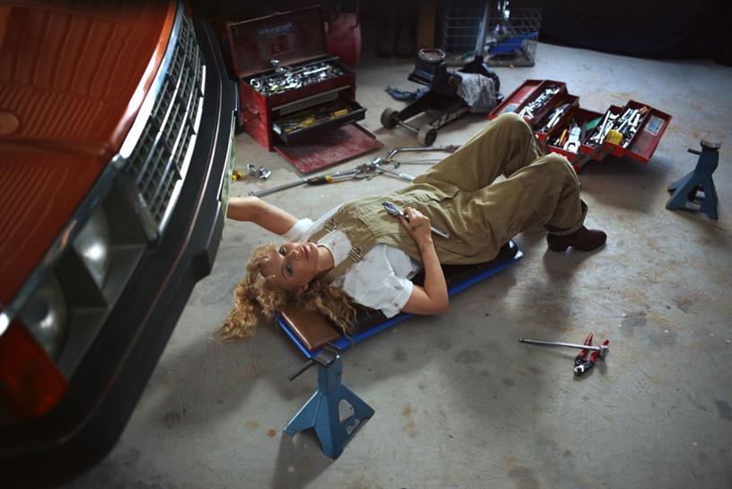  Kylie Minogue dressed as mechanic under a car