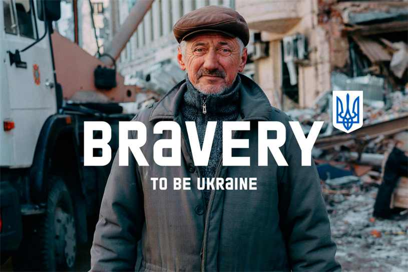 A Ukrainian man stands among the rubble caused by war