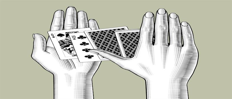 Hands holding playing cards 