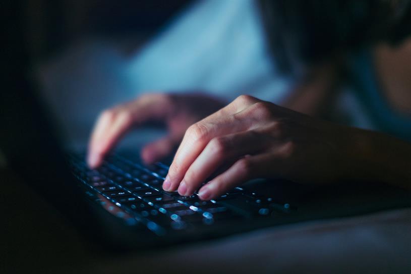 A photo of someone's hands tapping away at a PC keyboard