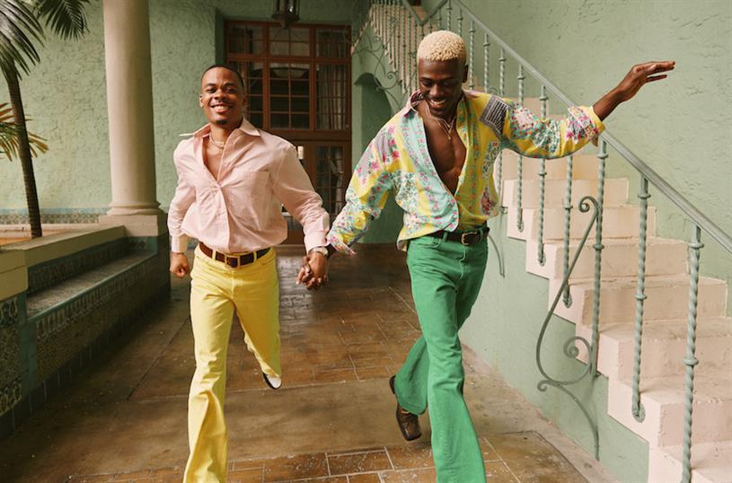 Orbitz' Travel As You Are campaign featuring gay black couple holding hands.