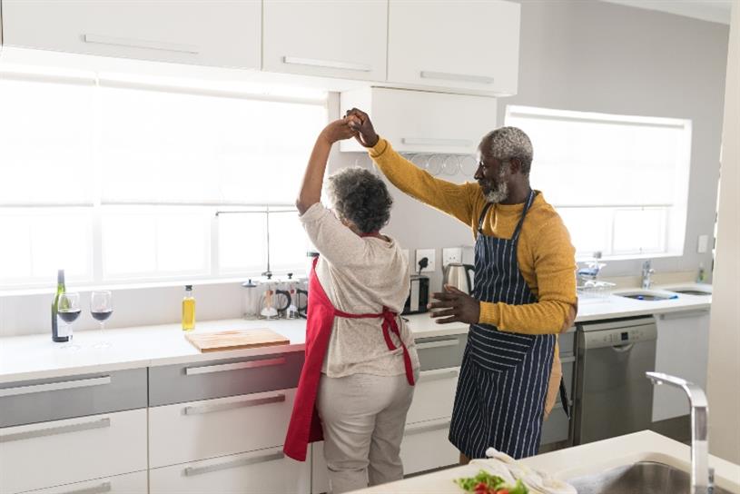 Elderly Black couple dancing in their kitchen