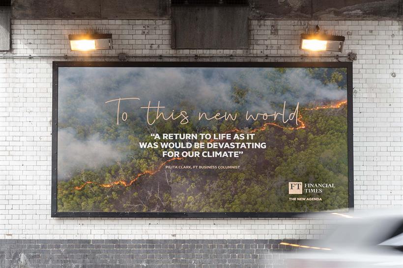 A Financial Times billboard with an image of a bushfire and the words "To This New World" and "A return to life as it was would be devastating for our climate"