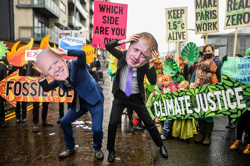 Protesters wear masks of Joe Biden and Boris Johnson during COP26.