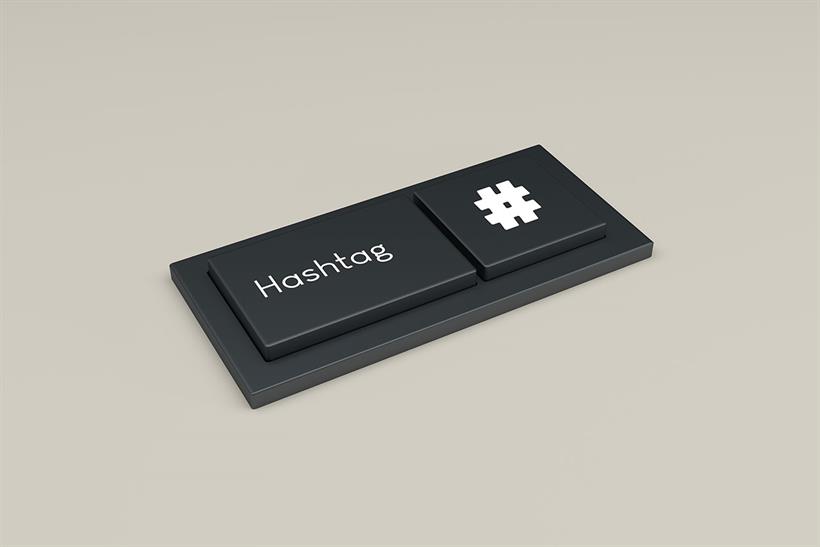 The word 'hashtag' and its symbol printed onto the keys of a keyboard 