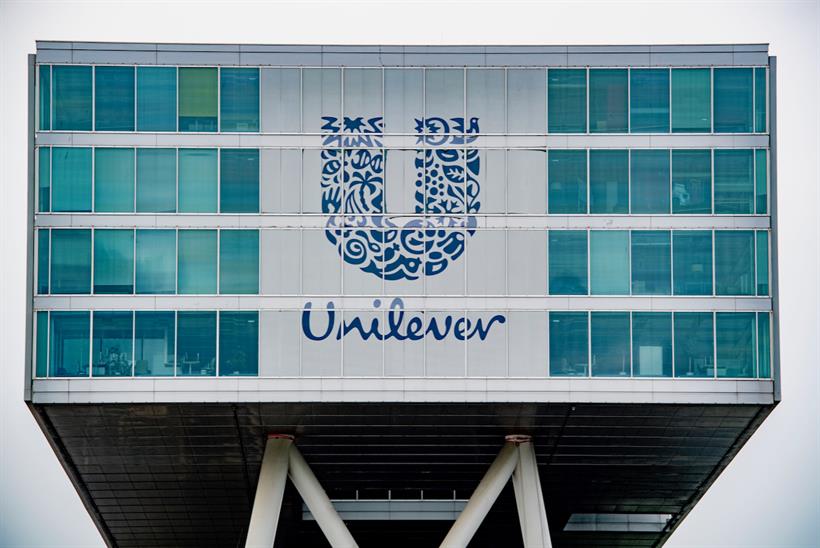 The Unilver logo on the front of a glass-fronted office building