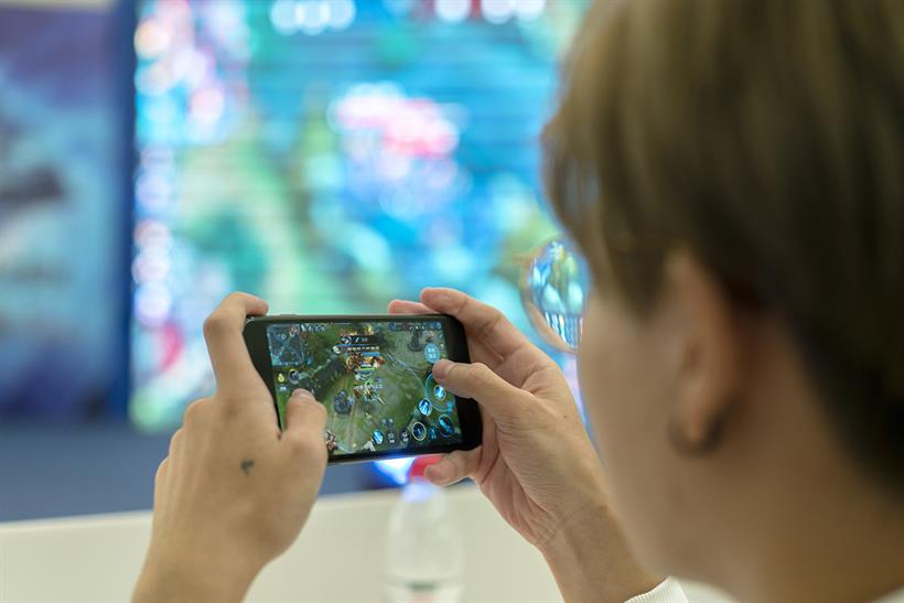A picture of a person playing a mobile game