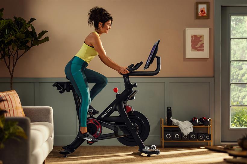 A woman using a Peloton exercise bike