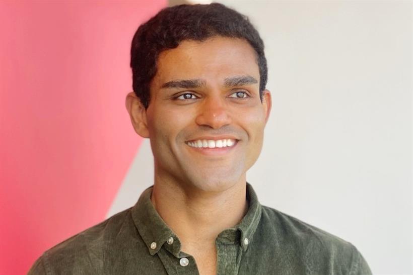 Rahul Titus, Ogilvy's UK and EMEA head of influence, sporting a dark green shirt, smiles as he stares into the middle distance
