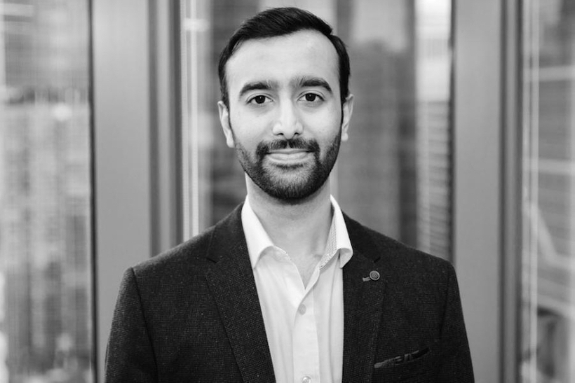 An black and white photo of Rohan Philips, the new president of global product for Dentsu International's media line, tentatively smiling and looking directly at the lens