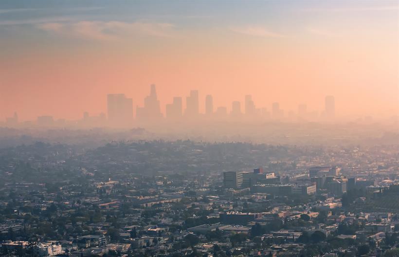 An image of a city skyline, obscured by smog