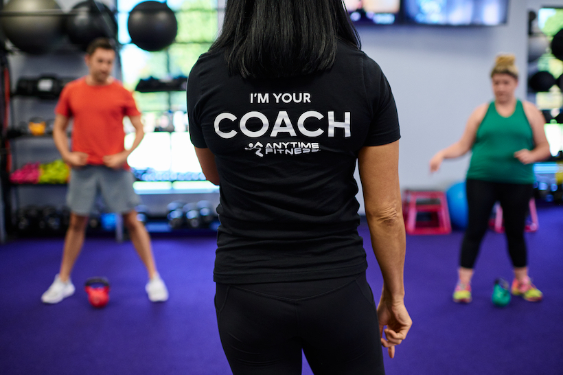Anytime Fitness coach wearing "I'm Your Coach" t-shirt