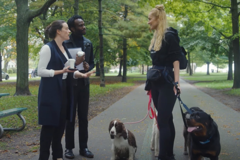 Awards Gone Wild ad screenshot showing people talking and walking dogs in a park.