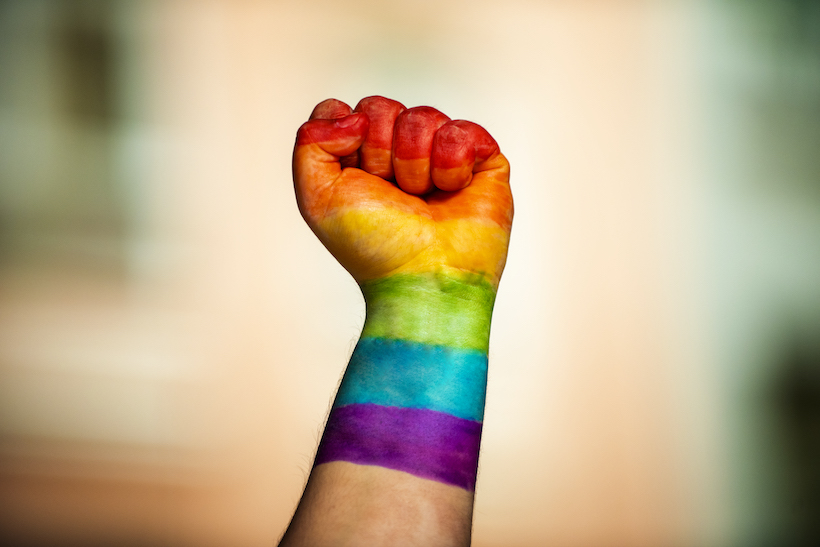 Rainbow-painted fist raised in LGBTQ solidarity