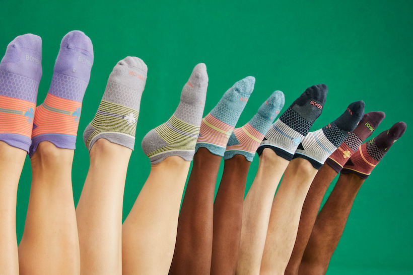 Diverse group of people wearing socks with only legs and feet visible