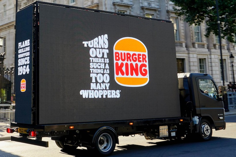 Burger King truck with words "Turns out there is such a thing as tom many whoppers"