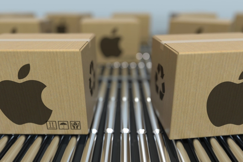 Apple cardboard computer boxes on conveyor belt in factory