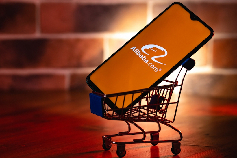 Smart phone displaying Alibaba.com logo in a toy shopping cart