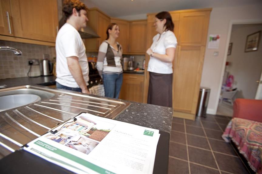 A young couple being shown around a house by an estate agent. Pic: Getty Images