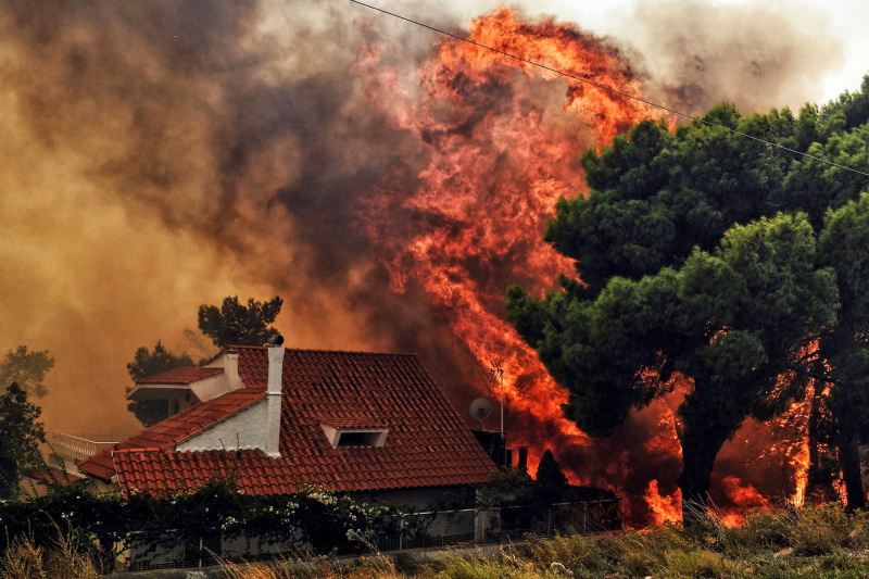 A wildfire engulfs a house in Euboea, Greece.