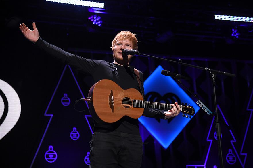 Ed Sheeran on stage holding a guitar