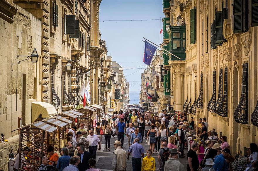 Pedestrians wander Valetta's Merchants Street (© istockphoto.com)