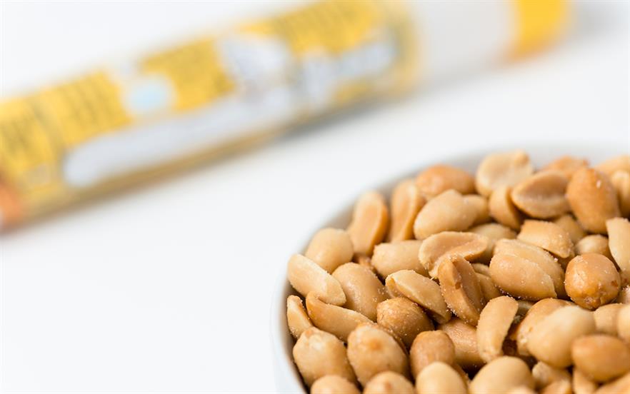 A bowl of salted peanuts is shown with an adrenaline pen in the background.